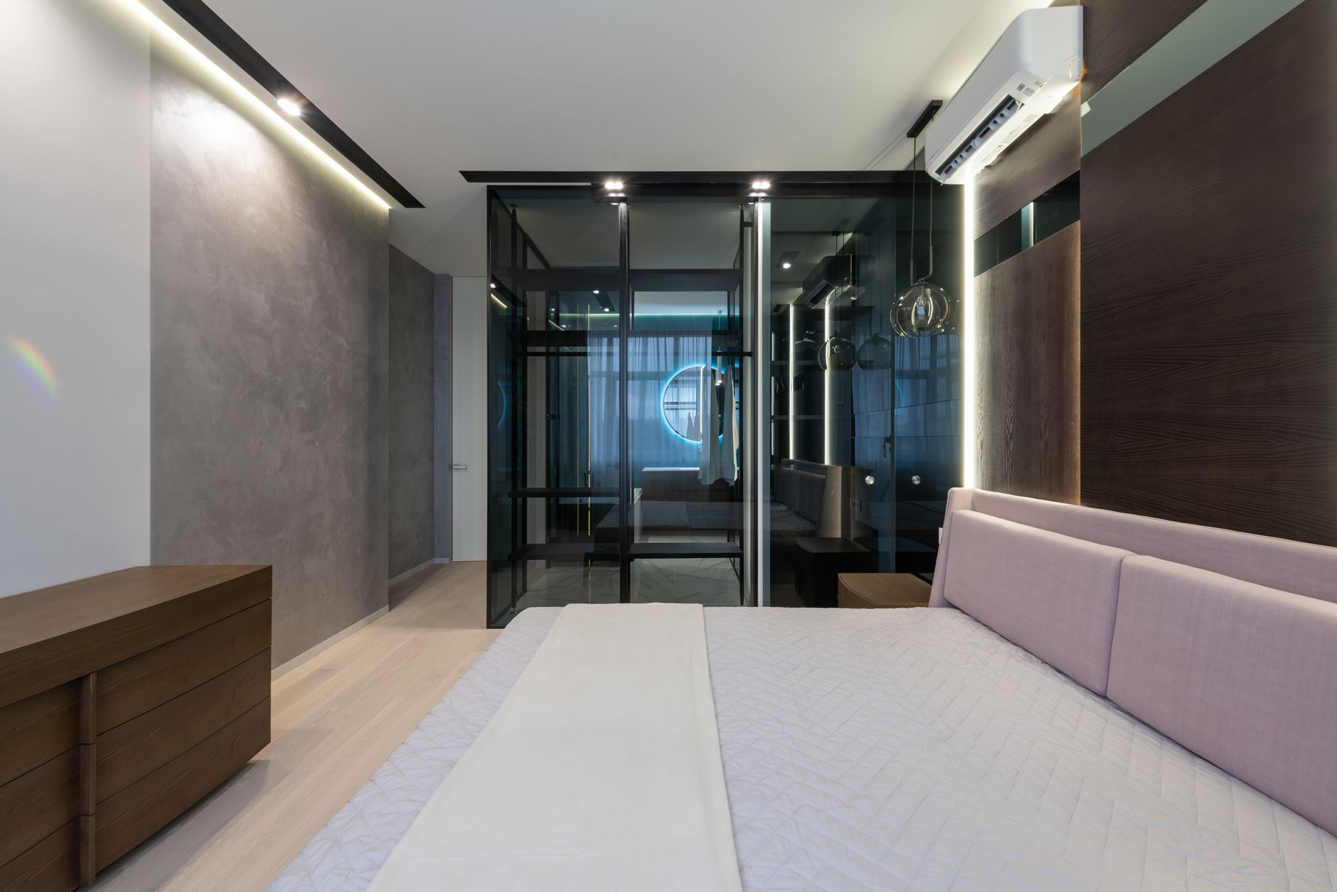 Airy bedroom with open window, light curtains, and a fan on a bedside table
