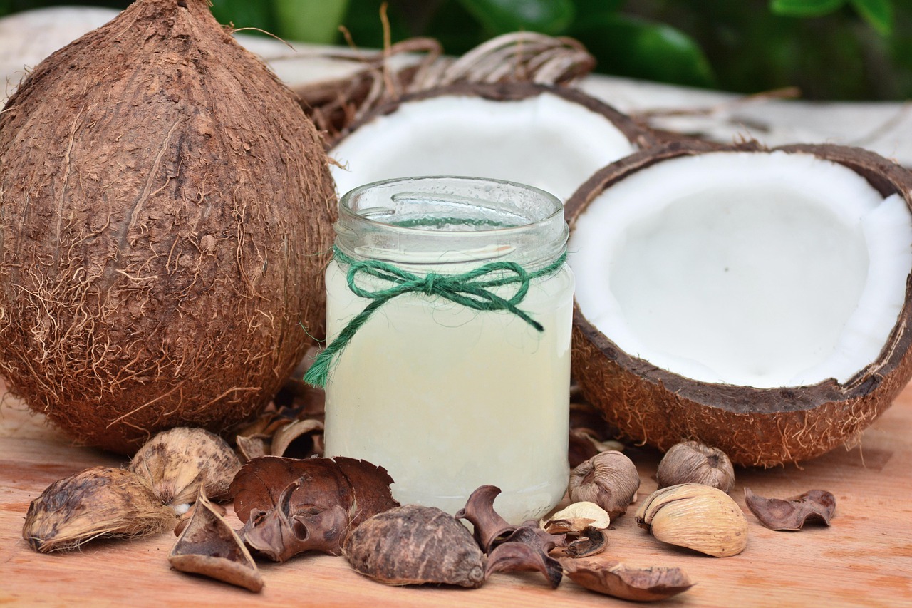 sandalwood powder in a small clay bowl next to sandalwood sticks on a natural wooden surface, warm ambient lighting