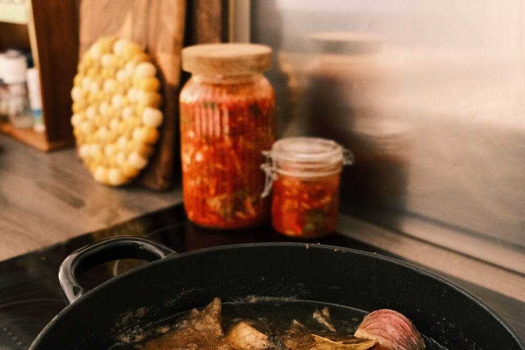 A pot of homemade broth on the hob in a rustic kitchen